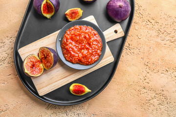 Plate with fig puree on color background, closeup