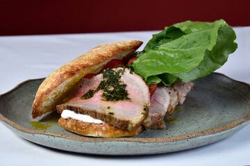 beef sandwich with rucula, cherry tomatoes and pesto