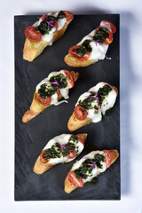 bruschetta bread with pesto cheese and tomatoes