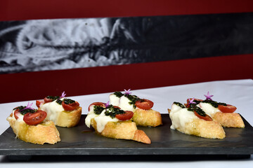 bruschetta bread with pesto cheese and tomatoes