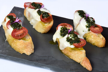 bruschetta bread with pesto cheese and tomatoes