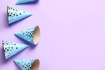 Party hats on violet background