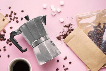 Geyser coffee maker, cup of espresso, sugar and bags with beans on pink background