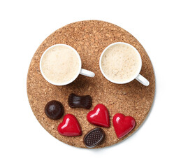Board with cup of latte and chocolate candies on white background. Valentine's Day celebration