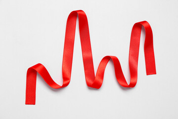 Cardiogram made of red ribbon on white background. Heart diseases concept