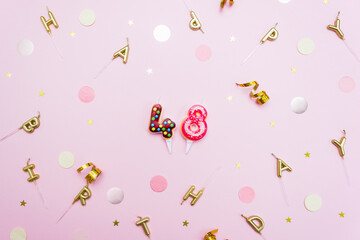 Numerals 48 in the form of sweet donuts are surrounded by festive decor. Forty eight year birthday celebration concept. Selective focus