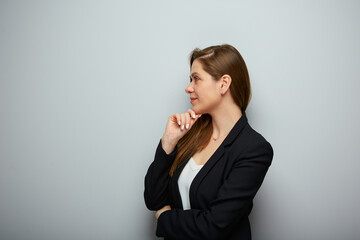 Smiling thinking business woman profile portrait with copy space.