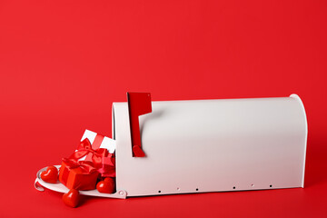 Mailbox with gifts and hearts on red background. Valentine's Day celebration
