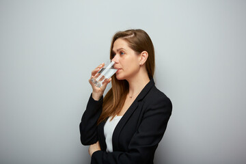 Woman drinking water. isolated female portrait with black suit.