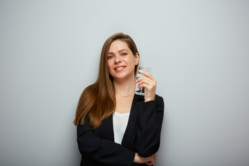 Smiling woman holding water glass. isolated female portrait with black suit.