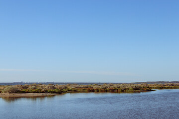 coastal landscape with distant leisure craft and shipping transportation