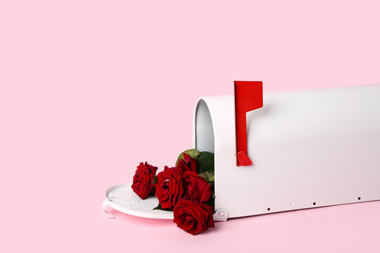 Mailbox with red roses on pink background. Valentine's Day celebration