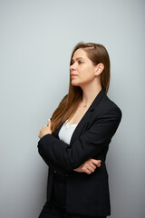 Profile portrait of thinking serious business woman in black suit looking at side.
