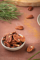 Pecan nuts in ceramic bowl on kitchen
