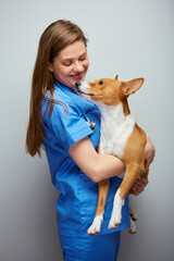 Smiling veterinarian doctor holding dog Isolated portrait.
