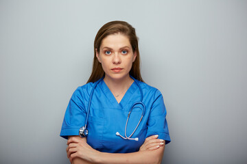Serious doctor woman or nurse in blue medical suit. Isolated portrait of female medical worker.