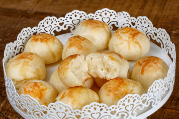 Portion of traditional Brazilian cheese bread on white tray
