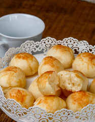 Portion of traditional Brazilian cheese bread on white tray