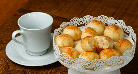 Portion of traditional Brazilian cheese bread on white tray