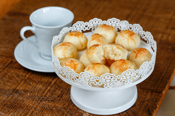 Portion of traditional Brazilian cheese bread on white tray