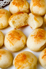 Portion of traditional Brazilian cheese bread on white tray
