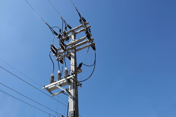 Equipment with electric wires on poles. Recloser is a circuit breaker-like device located in a...