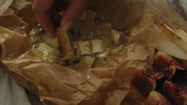 Cheese platter, appetizer snack table. Camembert cheese baked in the oven with garlic sauce and spices. Camembert with croutons in a baking dish. Cheese stretches, drips. Homemade brie in the oven.