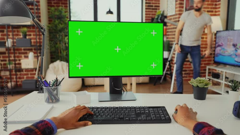 Poster office worker analyzing isolated greenscreen on computer to work with chroma key display on monitor.