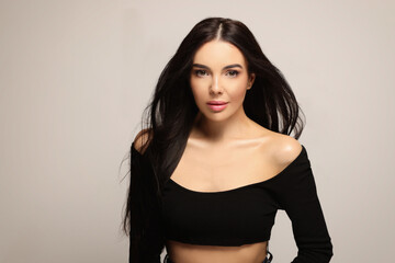 Fototapeta premium Portrait of beautiful young woman on light grey background