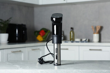 Thermal immersion circulator on table in kitchen. Sous vide cooking