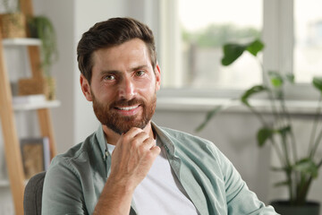 Naklejka premium Portrait of handsome bearded man at home, space for text