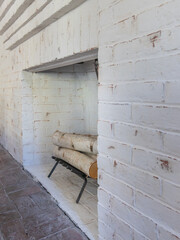 refinished modern white fireplace with birch logs