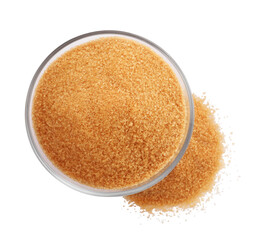 Glass bowl and granulated brown sugar on white background, top view