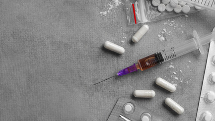 Different hard drugs on grey table, flat lay. Space for text