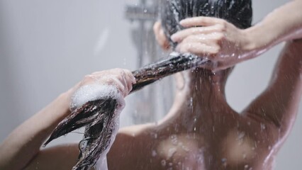 She takes a shower and uses shampoo like an Asian woman.