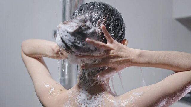 She takes a shower and uses shampoo like an Asian woman.