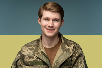 Young caucasian man wearing camouflage army uniform happy face smiling
