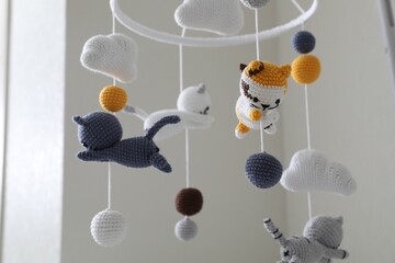 Modern baby crib mobile in children's room, closeup