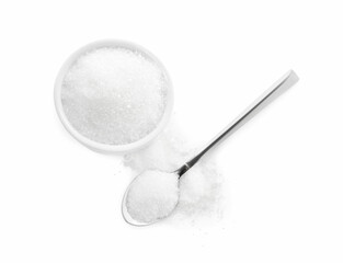 Bowl and spoon of granulated sugar on white background, top view