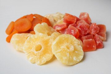 Pile of different dried fruits on white background, closeup