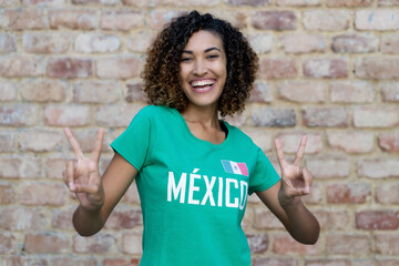 Laughing mexican woman loves the national soccer team