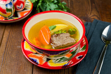 shurpa asian soup with beef on wooden table