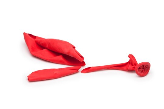 Ballon pop. Fragments of A Popped red balloon isolated on white. Stress, under pressure, fatigue, economy down concept. 