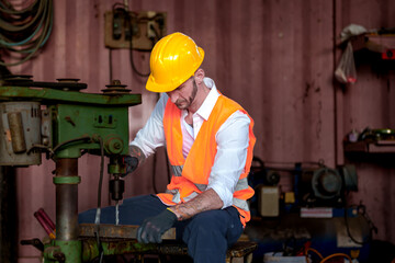 Drill press drilling a steel plate male metal worker using drill press