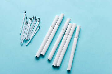 Cigarettes And Matches at Blue Background . Tobacco products