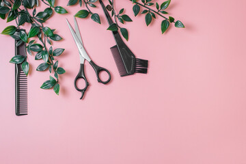 Tools hairdresser with a plant on a pink background.