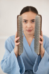 Asian woman holding sadhu boards on face background. 