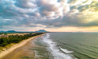 Aerial view of the central coast of Vietnam at dawn with the coast, blue sea waves, sunrise is a place for weekend relaxation and fishing of local fishermen