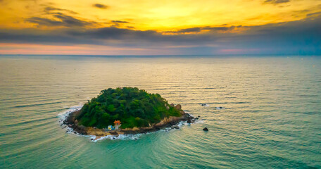Aerial view of sea landscape with deserted island in a turquoise water and sunrise sky background © huythoai
