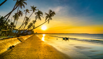 Dawn on the beach with tilted coconut trees, long sandy beach and beautiful golden sky and romantic...
